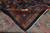 Folded corner revealing cotton foundation back and the clear pattern of hand-knotted weave