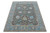 Angled full view of the 10'2" x 14' hand-knotted wool Oushak rug on white