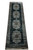 Angled full length shot of black and teal silk runner rug showing repeating floral medallion row