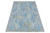 12x15 oversize Oushak rug photographed at an angle, showing all-over floral field and border