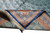 Corner folded back to reveal the fine silk weave, ivory fringe and navy selvedge edge