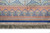 6' x 9' silk rug end border with repeating arch motifs in coral, blue and ivory