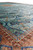 Low angle view of teal ogee panels filled with palmettes beside the coral diamond border