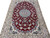 Angled floor view showing scrolling vine field, cream main border and navy guard stripes