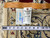 Reverse of rug with leather tag, inventory label and tape measure showing fine knotting