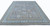 Large wool area rug laid flat, slate gray ground framed by wide blue border