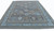 Blue palmettes and brown blossoms scattered across the gray field of this oversized rug