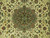 Close-up of sage green floral medallion with rust palmettes and turquoise accents on cream field