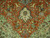Green spandrel corner detail with archers, horsemen and ivory pendant on this Persian hunting rug
