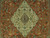 Close-up of ivory lobed medallion with blue center, leaping deer and flowering vines on rust ground