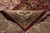 Folded corner showing tight hand-knotted back, cotton foundation and ivory fringe of the wool rug