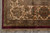 Ivory main border corner with green guard bands, paisley vines and burgundy outer edge binding