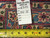 Back tag reading rug number 6347, size 11.4 x 16, beside a tape measure
