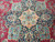 Central medallion in navy, turquoise and soft pink with 8 petal rosette at center