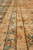 Close-up of narrow guard borders outlined in brown running along the light copper ground