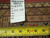Back of rug with hand woven Oriental rug tag reading 6343 and tape measure