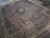 Angled view of navy and rust herati lattice with stepped hexagonal medallion and corner spandrels