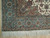 Corner detail showing green main border, camel guard band, ivory fringe and tight hand-knotted weave