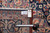 Reverse of the rug with tape measure and dealer tag confirming hand-woven Oriental construction