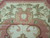 Ivory field detail with vine leaves, berry clusters and gold acanthus shield motif