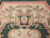Ivory spandrel detail with camel acanthus scrollwork, olive leaves and a small shield cartouche