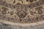 Main border with palmette cartouches, guard stripes and hand-tied cotton fringe along the round edge