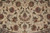 Symmetrical vine scroll drawing with multicolored palmettes filling the ivory field of this 9 x 9 rug