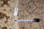 Tape measure and hand woven Oriental rug tag confirming the 9 x 9 round size