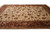 Angled studio view showing camel field, wide rust border and gold guard stripes