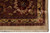 Corner close-up with rosette cartouche, red outlines, gold guard band and fringe