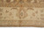 Straight-on view of the ivory border cartouche with soft rose outline and pale grey floral center