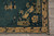 Corner detail showing camel scrolling vine border, navy outlines and stepped fret spandrel drawing