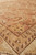 Angled close-up where cinnamon field meets tan border, paisley motifs and pile depth visible
