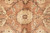Ivory rosette on cinnamon ground surrounded by thin tendrils and small pale blossoms