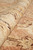 Macro close-up of plush hand-spun wool pile in ivory and rust showing dense texture