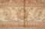 Straight-on border section with central lotus palmette flanked by curling leaf scrolls on tan