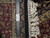 Ruler and authentic hand knotted tag beside fringe, showing fine knot count and wool pile
