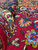 Thick wool pile shown at a folded edge, revealing dense knotting and saturated burgundy field color
