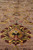 Low angle across the pile highlighting plush wool depth and silk sheen in floral motifs