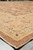 Low angle corner view highlighting multiple border bands in peach, gold and brown tones