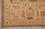 Corner detail of the all over floral border with ivory fringe and brown selvage