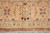 Peach border panel detail with sage green leaves and dark chocolate accents on wool