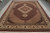 Angled floor view of the black and ivory Mahi Tabriz rug with deep red outer border
