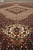 Low angle detail of the ivory pendant cartouche and fine herati knotting across the field