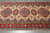 Close-up of ivory field showing octagonal and star medallions in red, navy and sky blue
