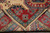 Folded corner revealing even hand-knotted wool weave, cotton fringe and clean reverse of the runner
