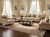 Beige living room styled with cream sofas, dark wood table and floral Persian Kerman area rug