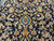 Detailed navy field of scrolling vines, ivory palmettes and olive leaves around a small turquoise motif