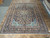9'10" x 12'11" Kashan rug laid flat on tile floor, inventory tag reading 6286 visible