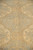 Low angle macro of beige palmette outlines against a soft sage field, showing wool sheen